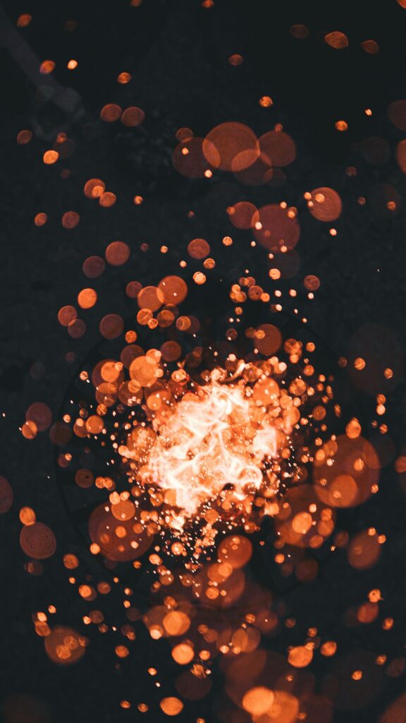 Vibrant Orange Bokeh Wallpaper: Glowing Circles on Dark Background