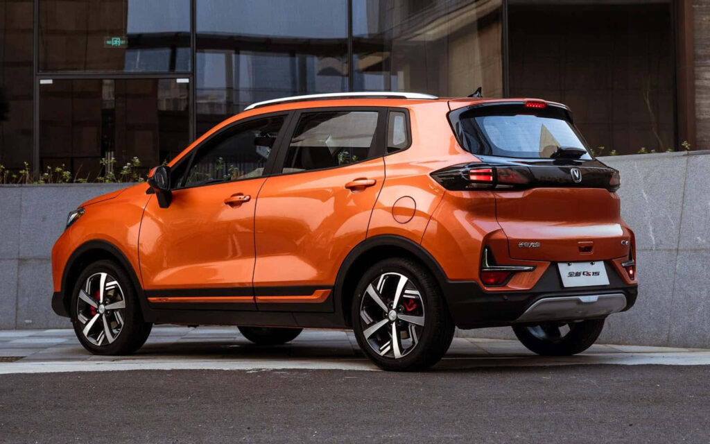 Vibrant orange Changan SUV with sleek black accents and sharp rear LED lights in urban setting Wallpaper