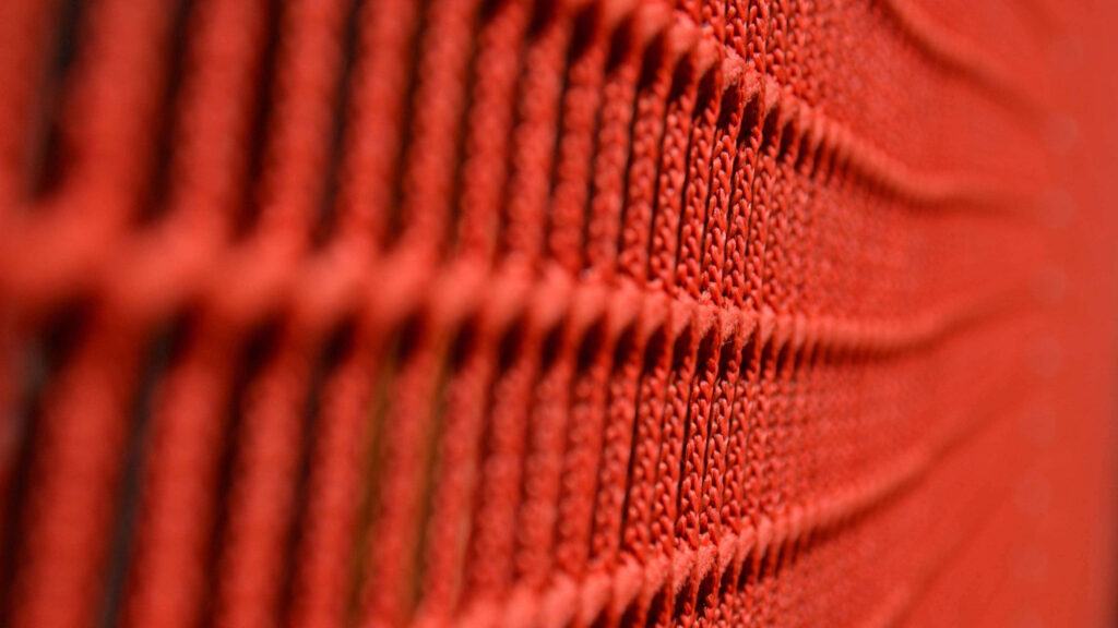 Vibrant Orange Fabric Wallpaper: Intricate Patterns & Warm Texture