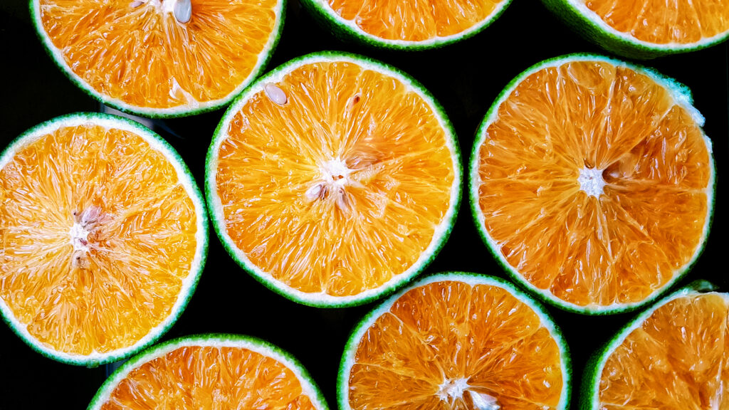 Vibrant Orange Halves Wallpaper: Fresh & Zesty Background Display