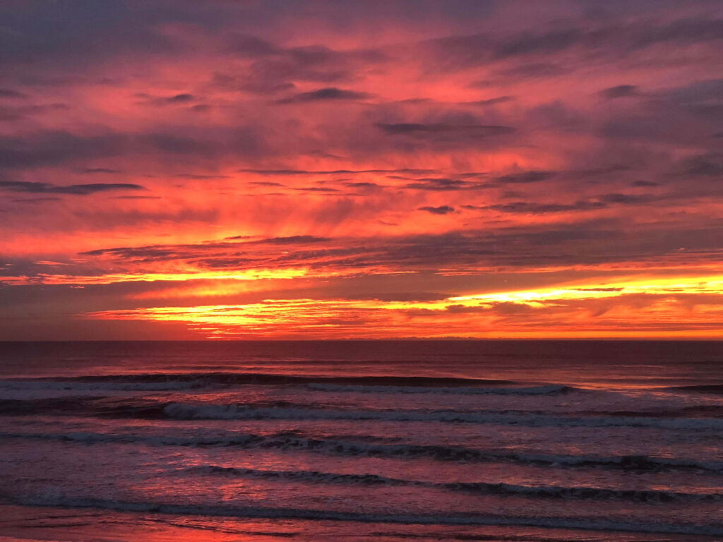 Vibrant Sunset Over Calm Ocean: Serene Orange & Pink Sky Background Wallpaper