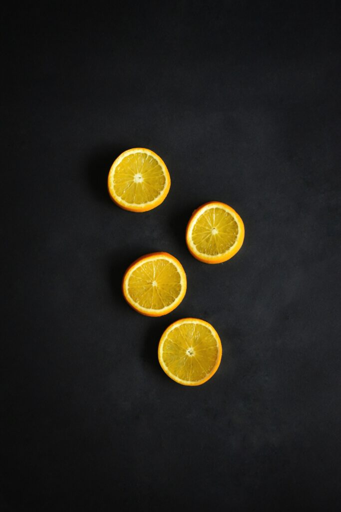 Vibrant Orange Slices Minimalist Wallpaper on Dark Background