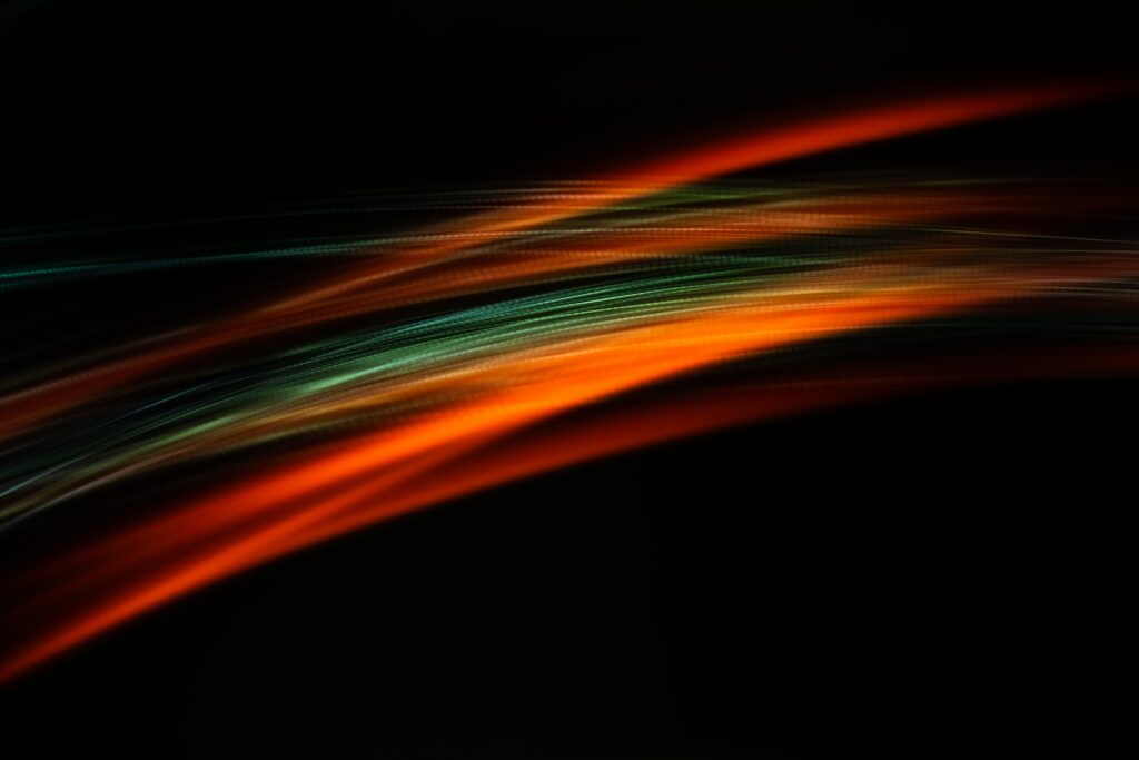 Vibrant Orange and Teal Abstract Light Trails Wallpaper Background