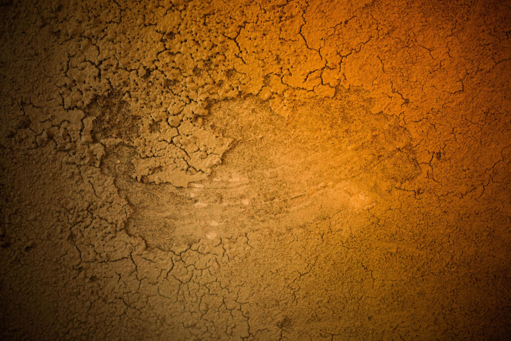 Rustic Cracked Wall Wallpaper with Vibrant Orange Overlay
