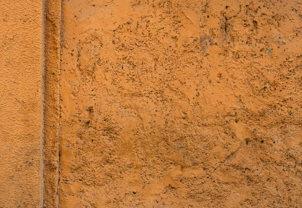 Vibrant Orange Transformation: Stone Wall Background Unveils Textured Beauty Wallpaper