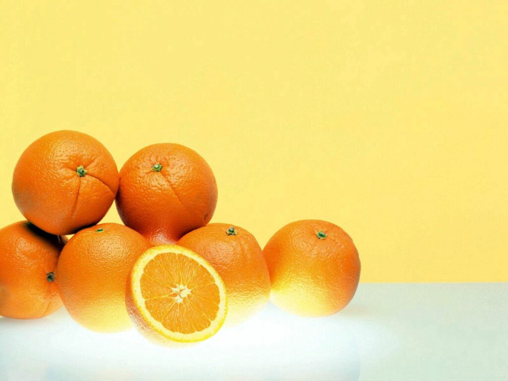 Vibrant Orange Wallpaper Background: Freshness on Bright Yellow