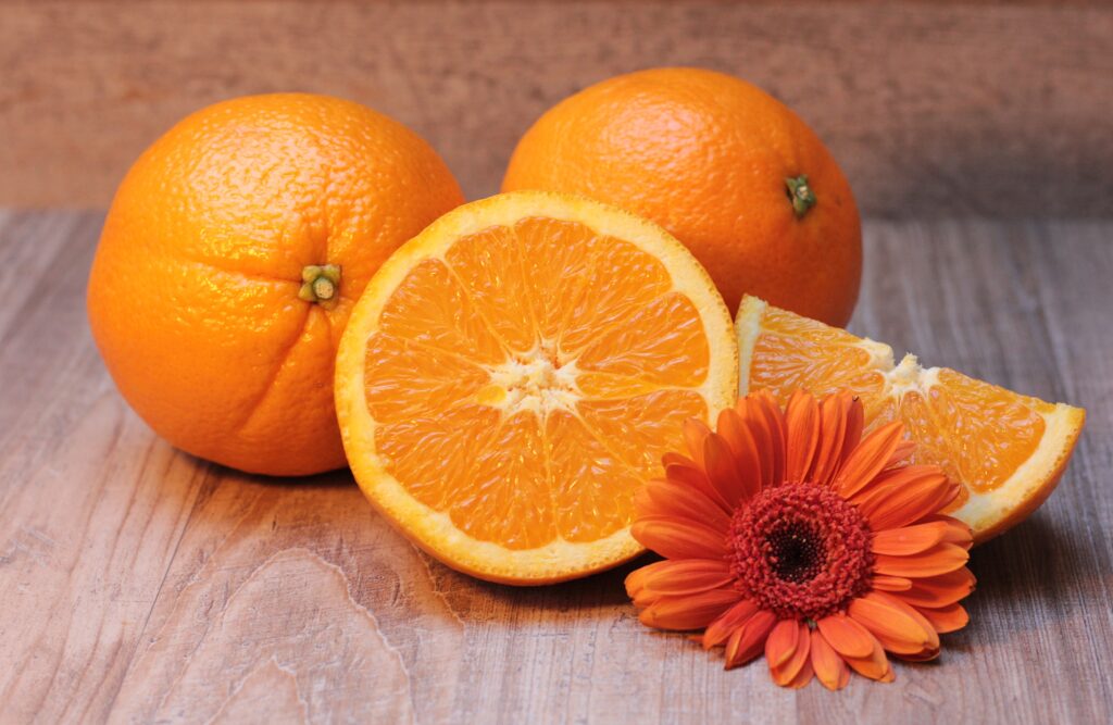 Vibrant Orange Wallpaper: Fresh Oranges & Bright Flower on Wood