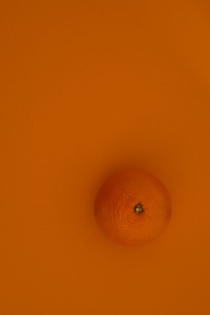 Minimalist Orange Wallpaper with Fruit on Vibrant Background