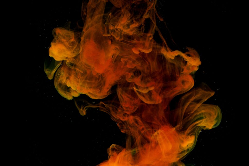 Vibrant Orange & Yellow Smoke Swirls on Dark Background - Ethereal Art Wallpaper
