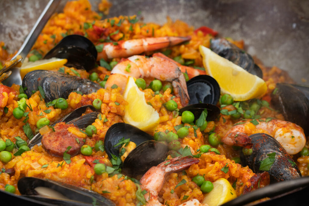 Vibrant Paella Closeup: Shrimp, Mussels & Saffron Rice Wallpaper