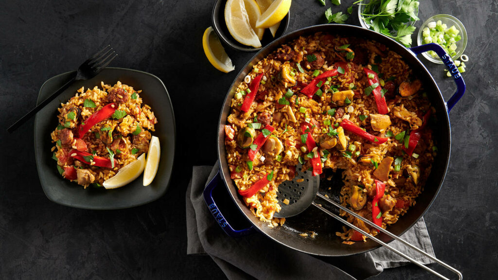 Vibrant Spicy Paella Wallpaper: Seafood, Rice & Colorful Ingredients
