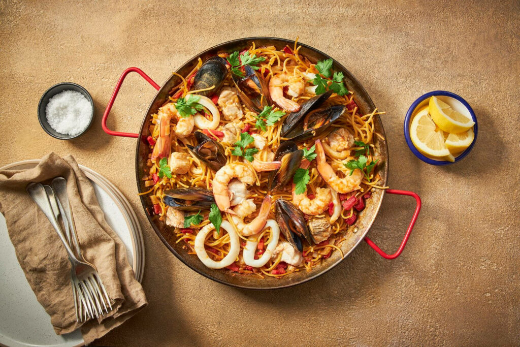 Vibrant Paella Wallpaper: Flavorful Mediterranean Dish Background