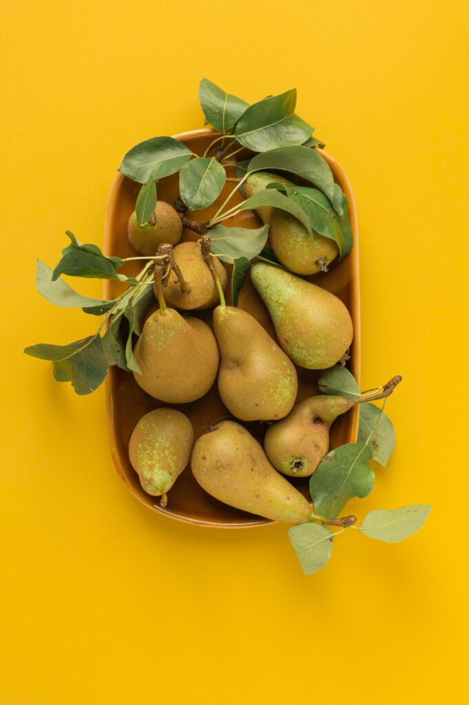 Vibrant Pear Wallpaper: Fresh Ripe Pears and Green Leaves Background