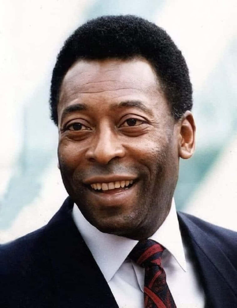 Vibrant Pelé Wallpaper: Charismatic Soccer Icon in Formal Attire