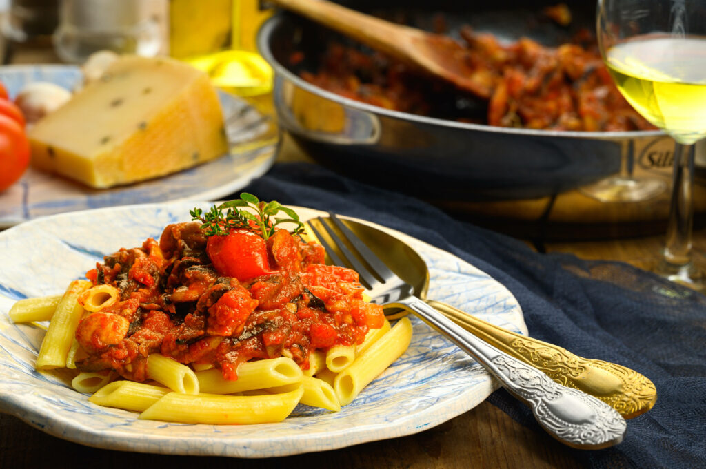 Vibrant Penne Pasta Wallpaper: Cozy Kitchen with Tomato Sauce & Herbs