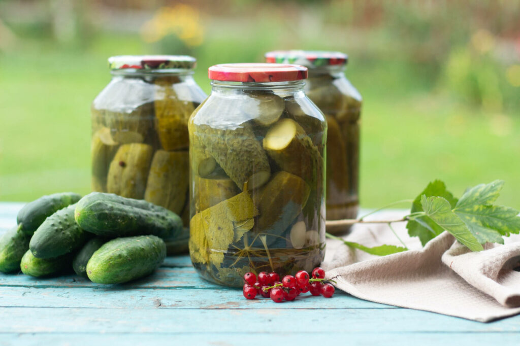 Vibrant Pickled Cucumbers in Jars: Rustic Outdoor Wallpaper