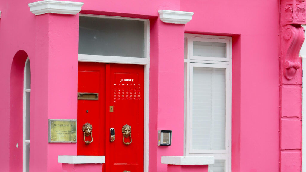 Vibrant pink building with red door elegant doorknockers January 2022 calendar wallpaper background