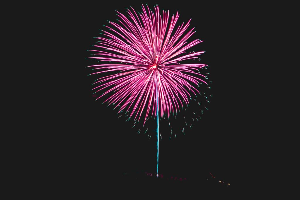Vibrant Pink Firework Explodes: Stunning Wallpaper Background