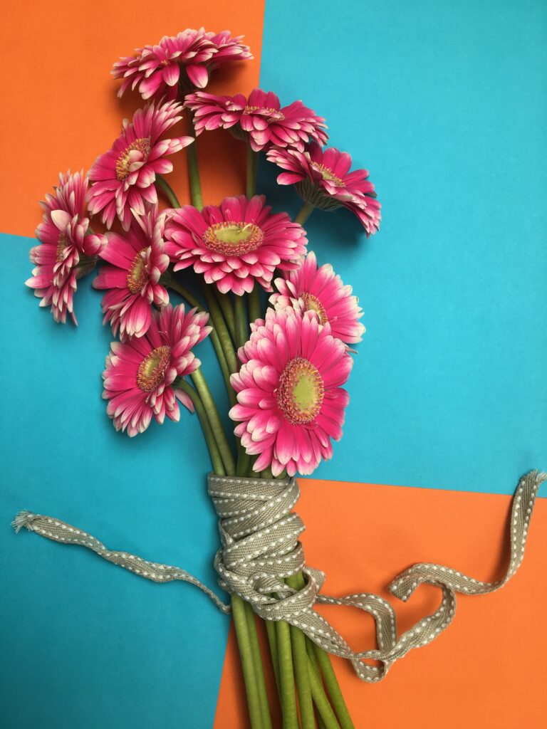 Vibrant Pink Gerbera Bouquet Wallpaper with Bold Orange & Blue Design