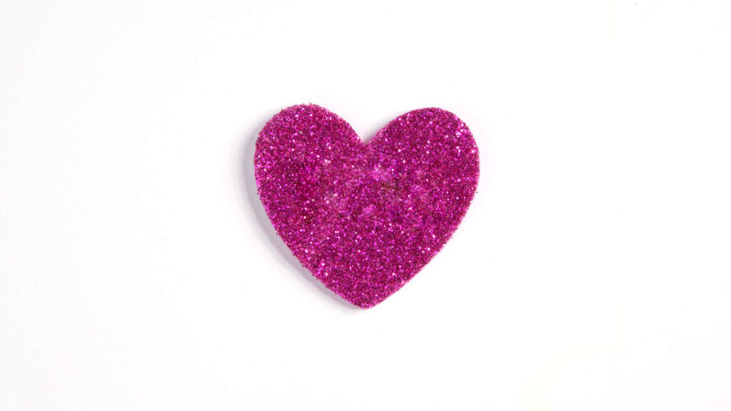 Vibrant Pink Glitter Heart Sticker on Clean White Wallpaper Background