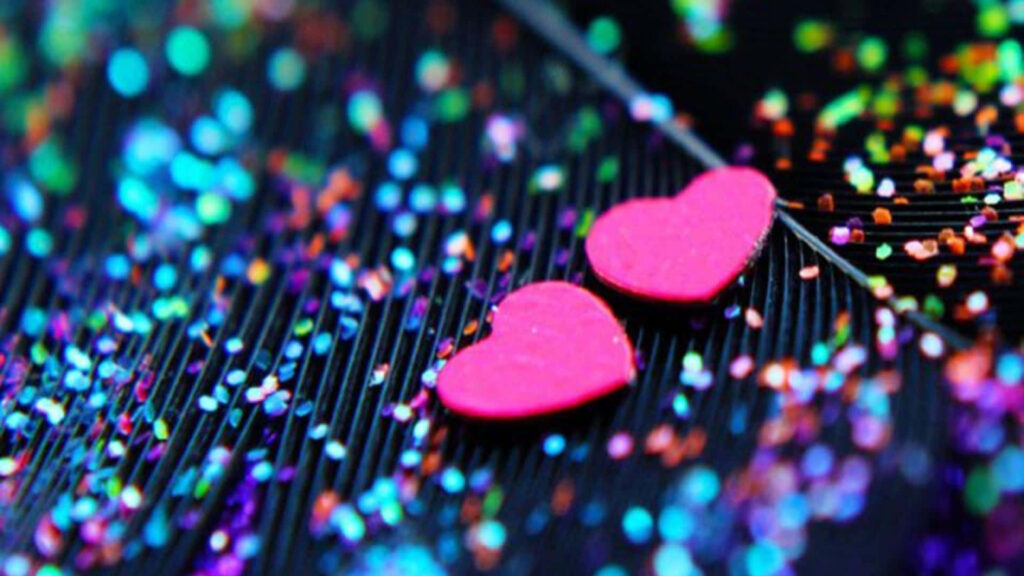 Vibrant Pink Glitter Hearts on Textured Black Wallpaper Background