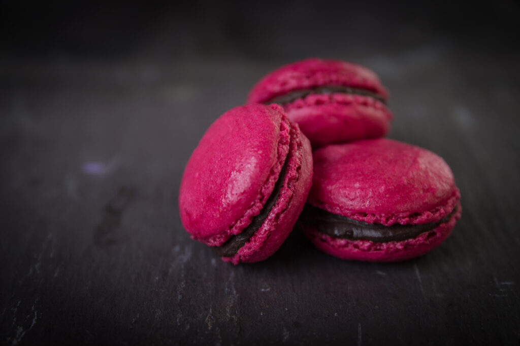 Vibrant Pink Macarons with Chocolate Filling - Textured Wallpaper