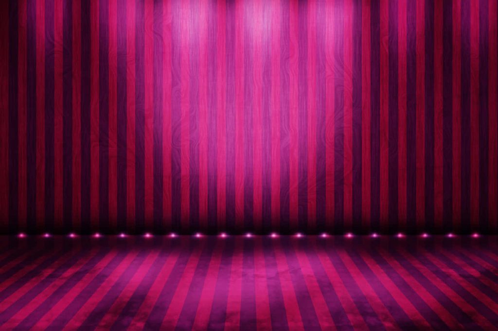 Vibrant pink and purple striped stage background with dramatic spotlights and floor lights Wallpaper