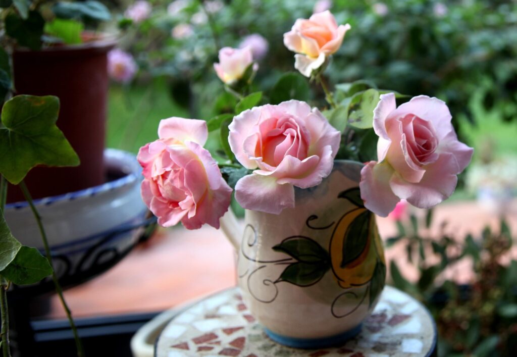 Vibrant Pink Roses in Decorative Vase - Stunning Floral Background Wallpaper