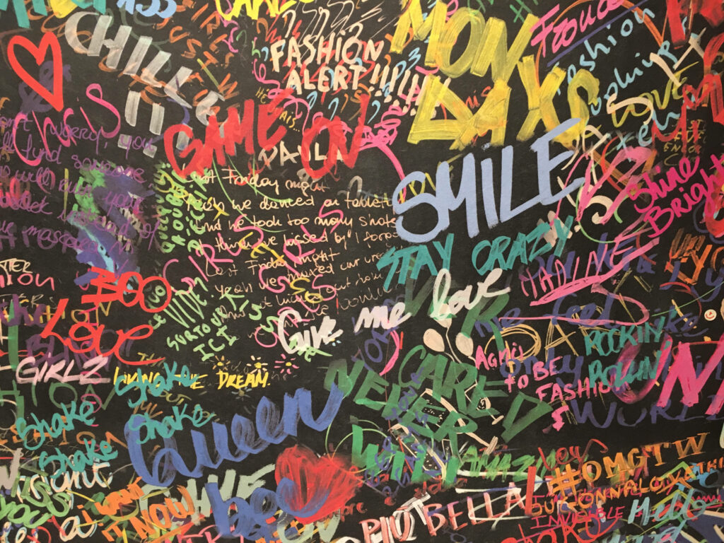 Vibrant pop art wallpaper with colorful words on dark background for creative modern spaces
