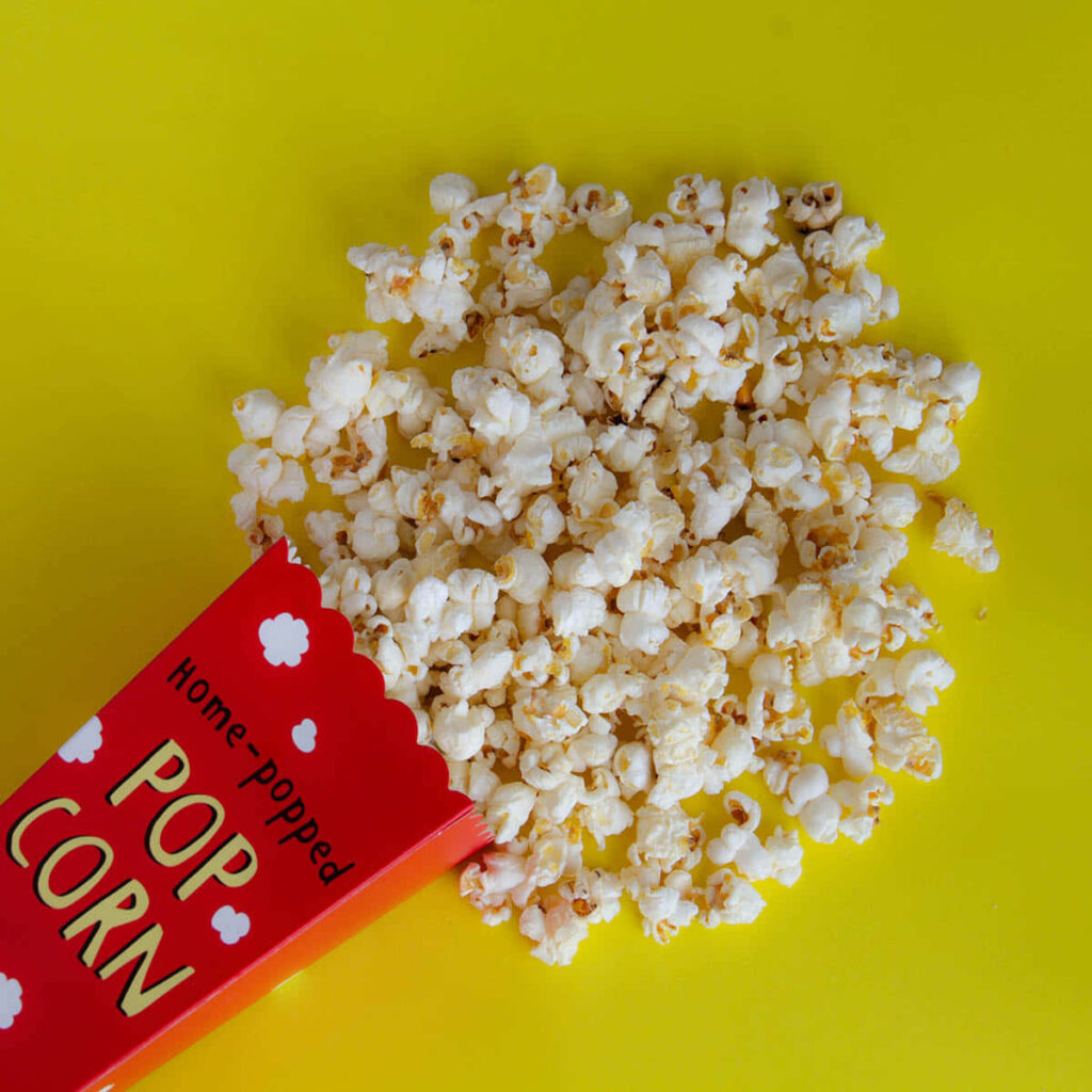 Vibrant Popcorn Wallpaper: Freshly Popped in a Red Box on Yellow