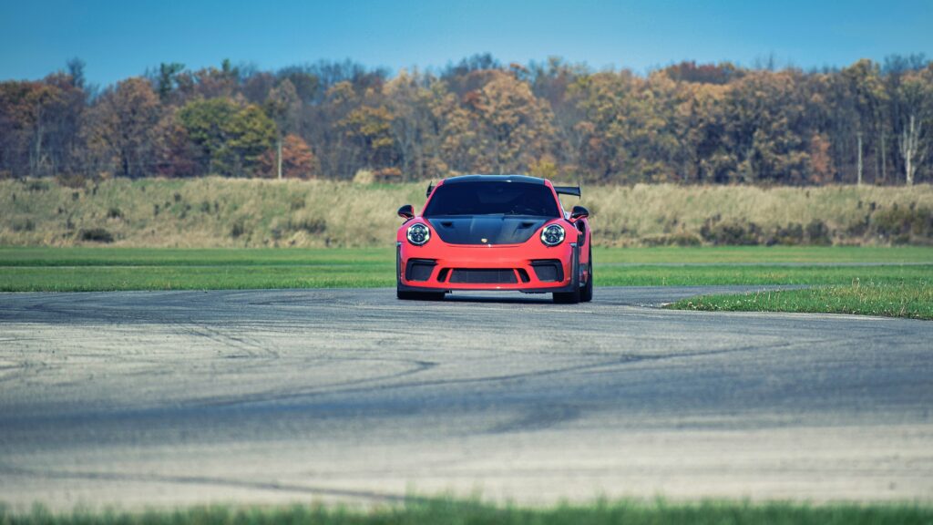 Vibrant Porsche 911 GT3 on Racetrack: Dynamic Performance Wallpaper