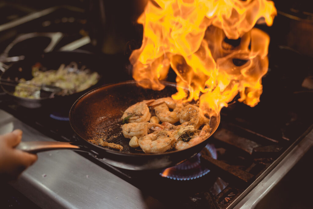 Vibrant Wallpaper: Flambéed Prawns in Wok - Dynamic Cooking Scene