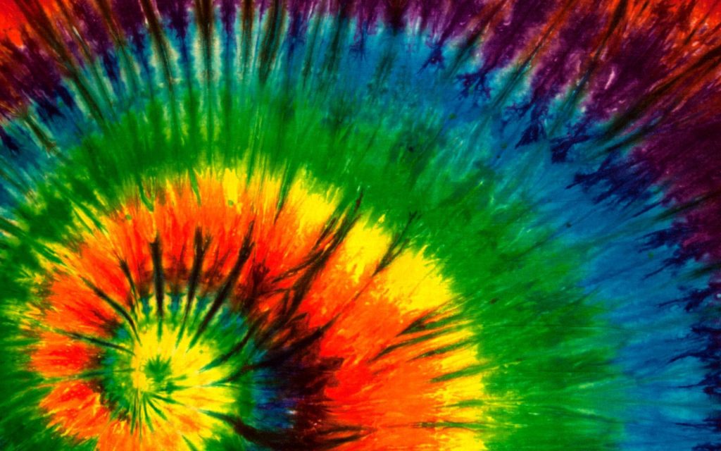Psychedelic tie-dye spiral wallpaper with vibrant yellow orange red and blue retro design background