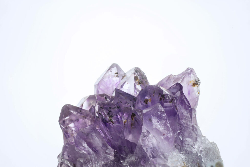 Natural amethyst shards wallpaper with vibrant purple crystals and bright clean background