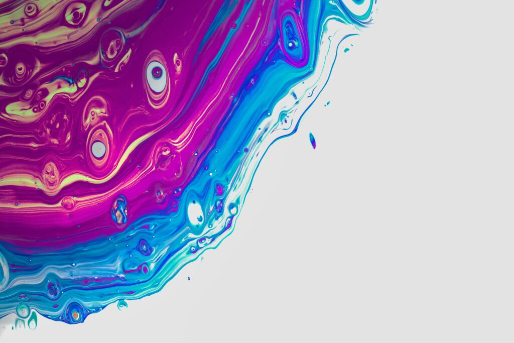Vibrant Purple and Blue Liquid Paint Swirls Abstract Wallpaper