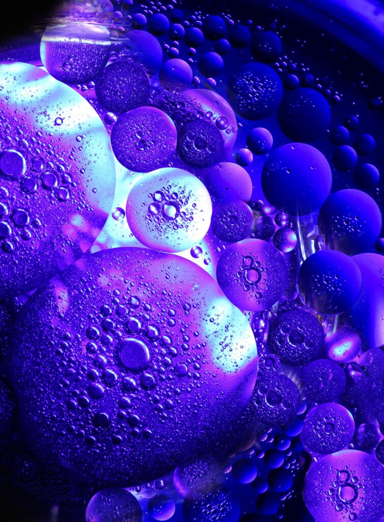 Vibrant Purple Bubble Wallpaper: Stunning Circular Design on Dark Background