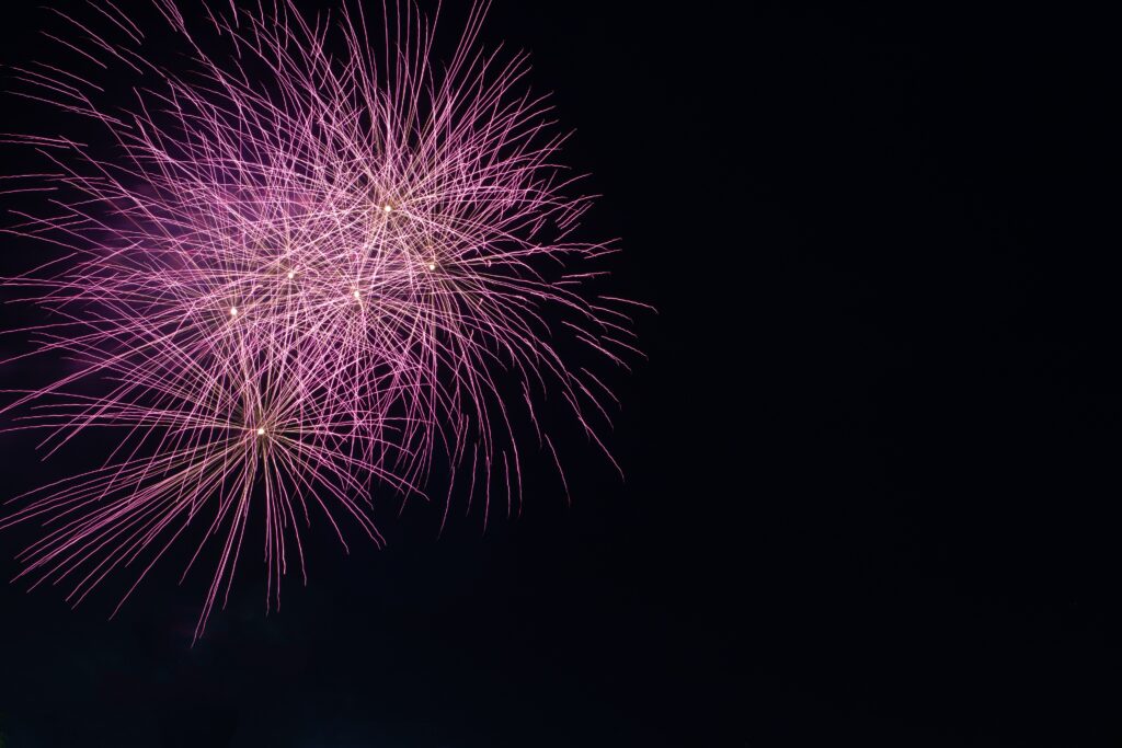 Vibrant Purple Fireworks Wallpaper: Captivating Night Sky Background
