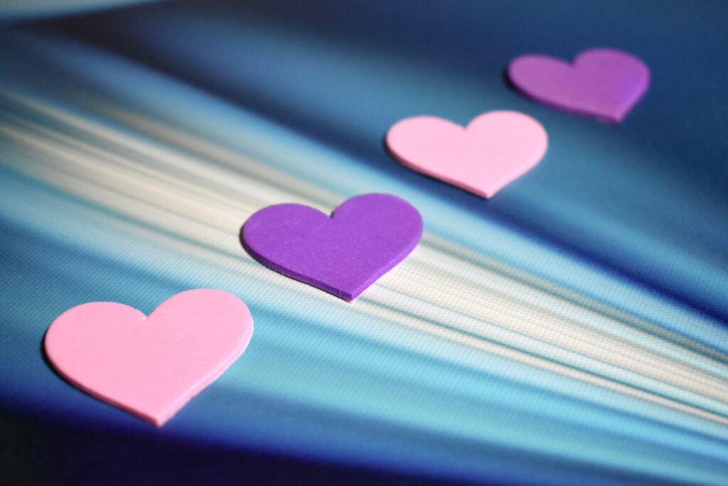 Vibrant Purple & Pink Heart Wallpaper on Radiant Blue Background