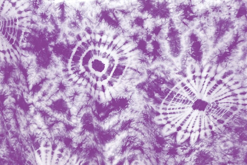 Vibrant purple and white tie-dye wallpaper with circular abstract patterns and bohemian style