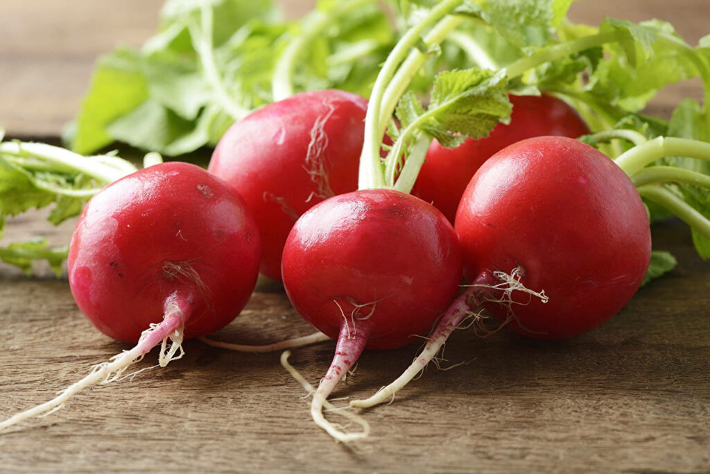 Vibrant Red Radishes Wallpaper: Rustic Wooden Background Texture