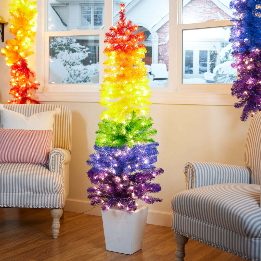 Vibrant Rainbow Christmas Tree Wallpaper in Cozy Indoor Setting