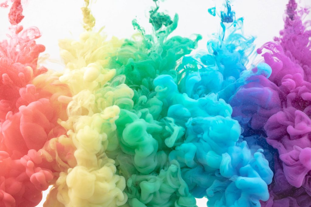 Vibrant rainbow ink swirling plumes on white background high quality colorful abstract wallpaper