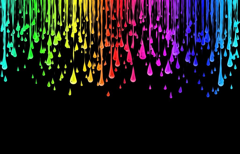Rainbow paint droplets cascading on black background vibrant abstract drip wallpaper