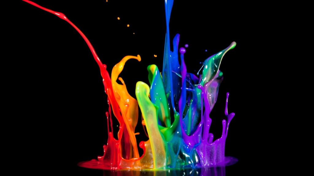 Vibrant rainbow paint splash dynamic explosion on sleek black background desktop wallpaper