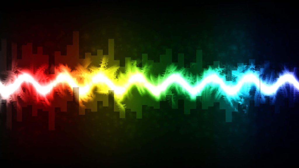 Vibrant rainbow soundwave wallpaper with glowing neon bars on dark background for modern desktops