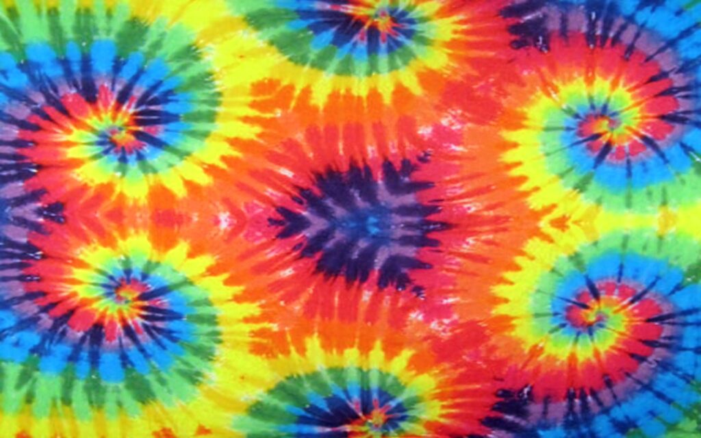 Vibrant tie dye wallpaper with swirling rainbow colors and psychedelic retro design background