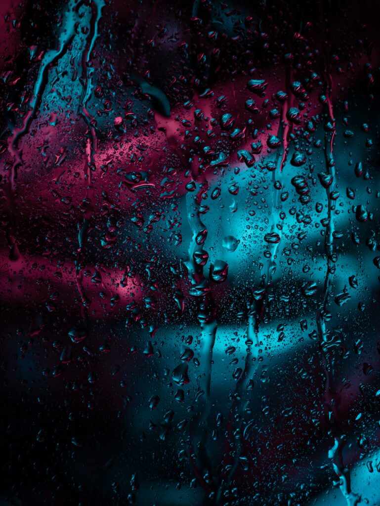 Neon Raindrop Wallpaper: Moody Blue & Pink Glass Surface Design