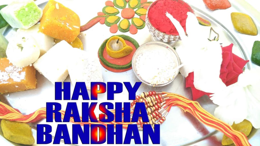 Raksha Bandhan festive thali with sweets rakhi diya kumkum rice vibrant Indian celebration background Wallpaper