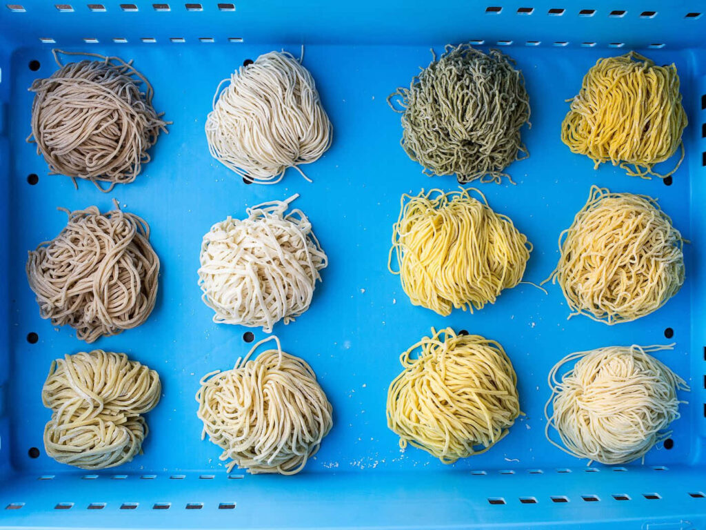 Vibrant Ramen Noodles Wallpaper Background in Colorful Assortment
