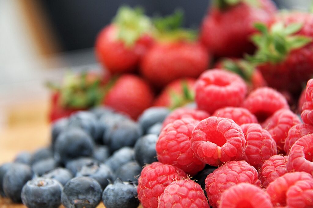 Vibrant Raspberry & Blueberry Wallpaper Background with Blur Effect